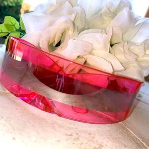 Neon pink sunglasses with silver fashion band.